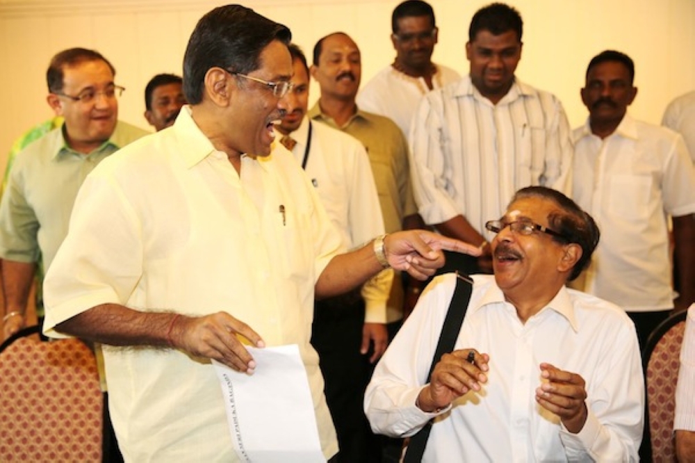 Datuk Seri Dr S.Subramaniam (left) and Datuk Seri G.Palanivel (sitting) sharing a light moment in 2013 before their rift in 2015. — Picture by Choo Choy May